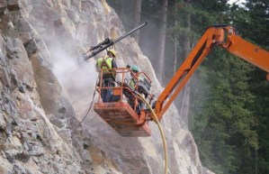 Crews burrowing into mountain to plant charges)